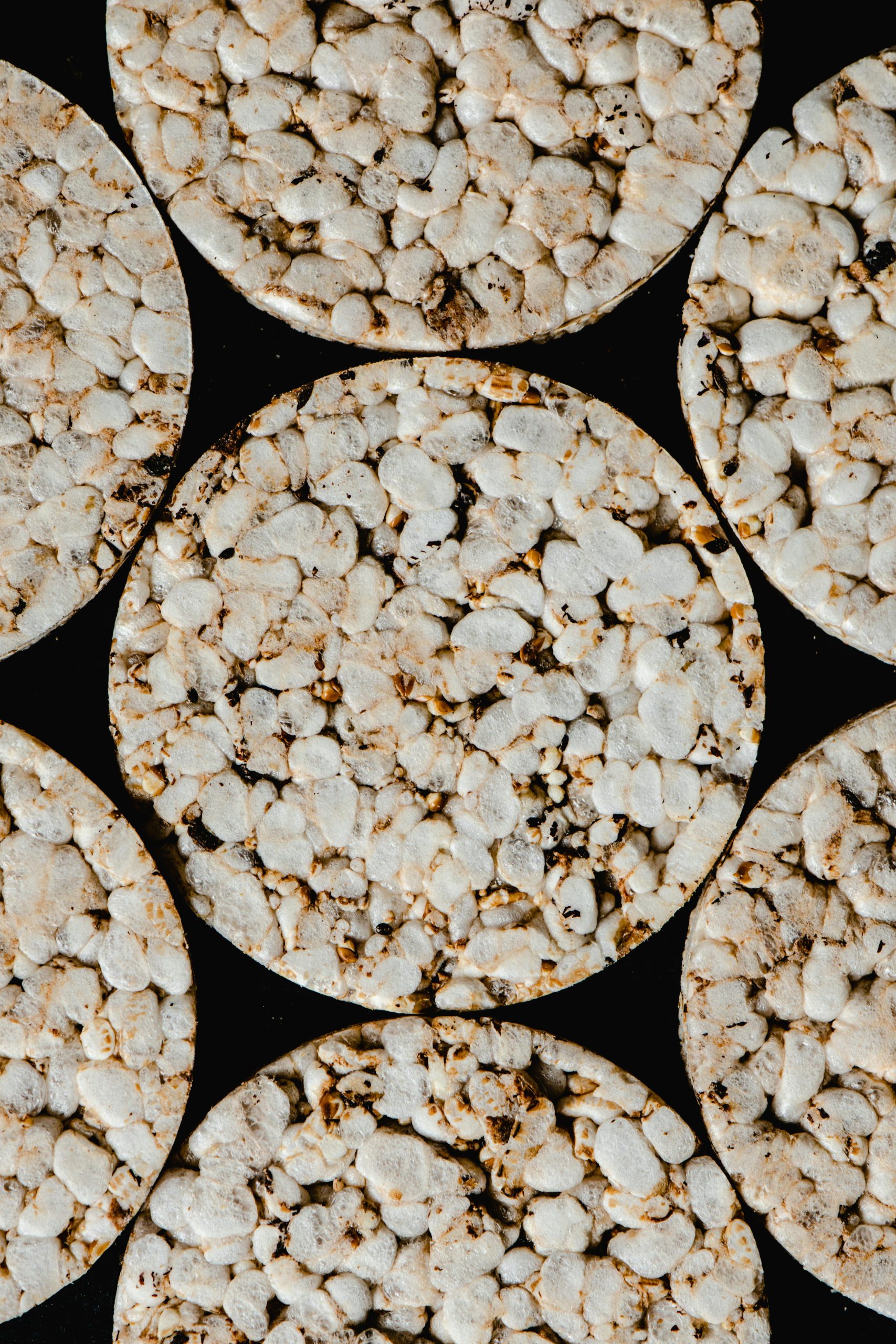 Top view of round rice cakes showcasing texture and pattern. Ideal for food-related themes.